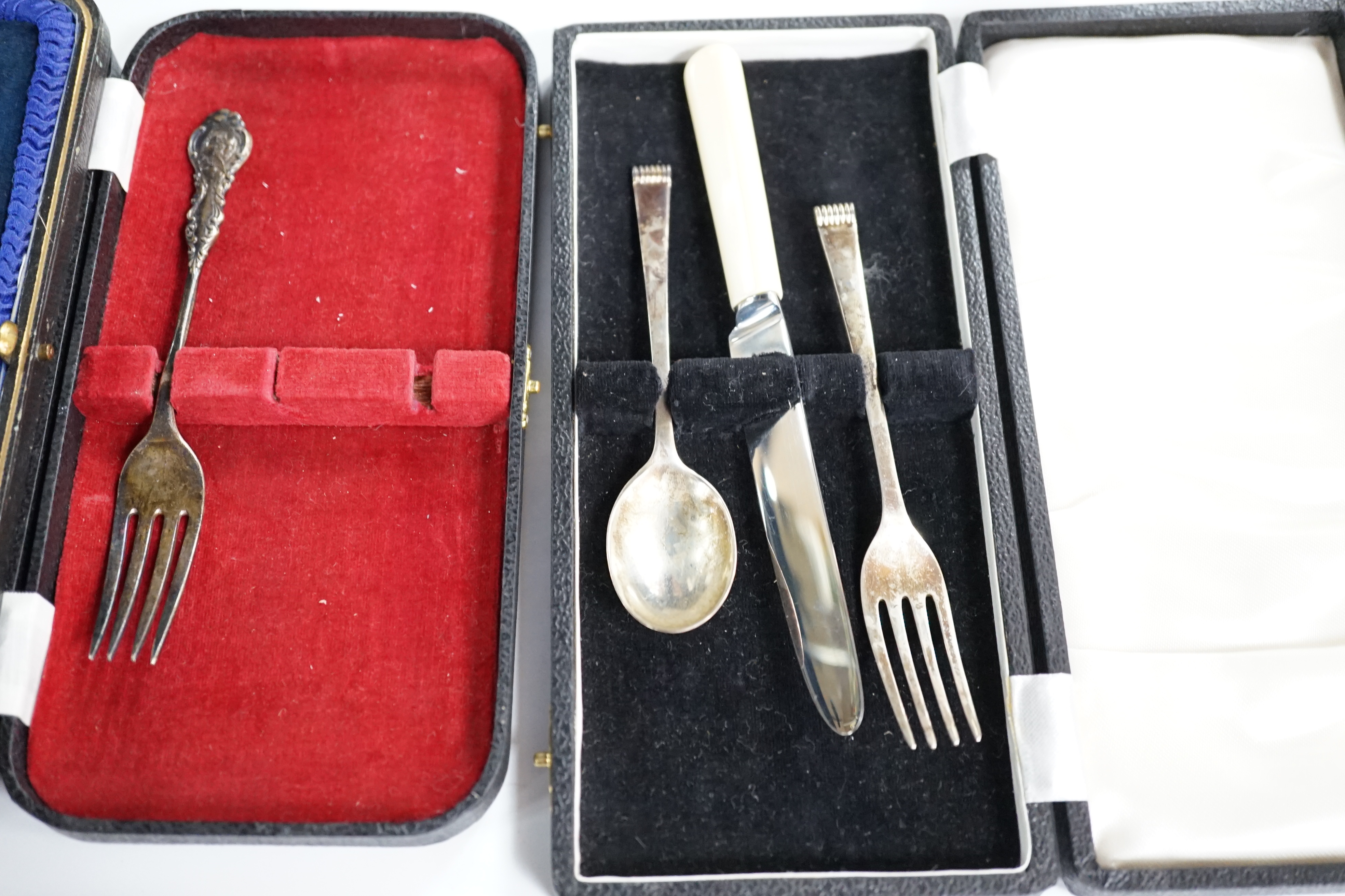 A cased set of six mid 20th century silver teaspoons, a cased silver spoon and pusher, two cased silver christening sets, a boxed silver spoon and one other incomplete cased set. Condition - poor to fair